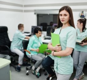 Medical theme .Portrait of female doctor with clipboard against group of doctors meeting in the mri office at diagnostic center in hospital.
