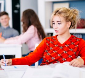 student-taking-notes-library